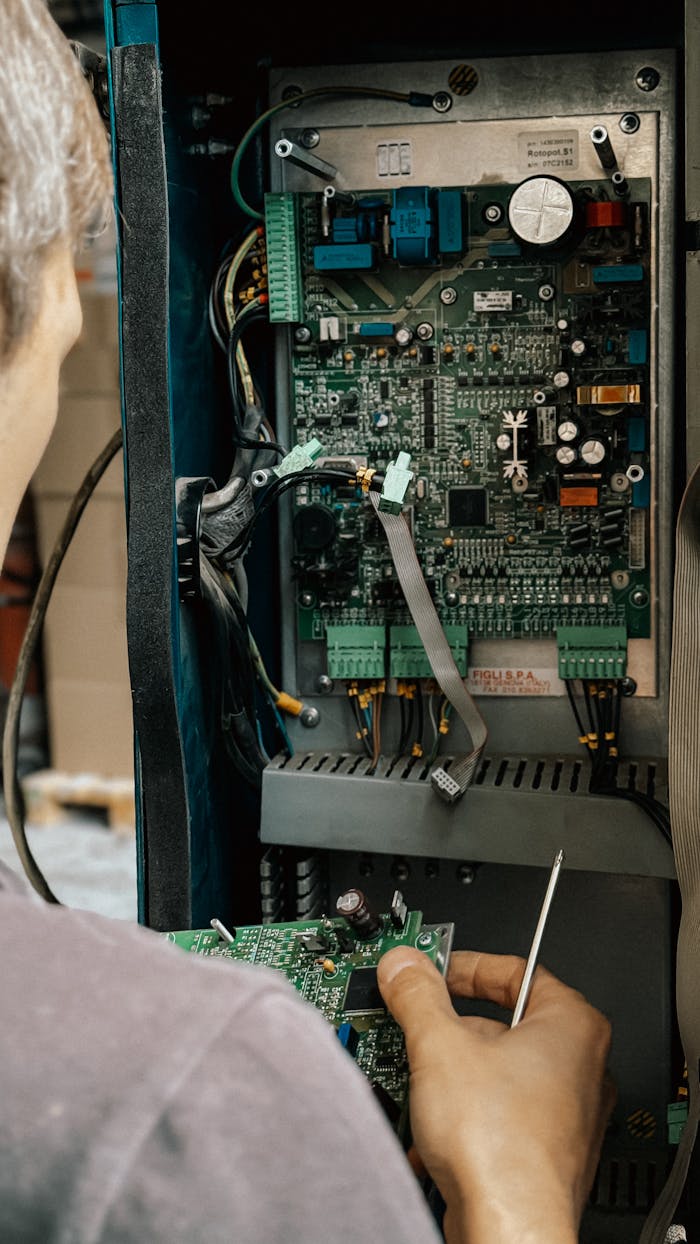 creative Professional technician fixing circuit board in an industrial setting.